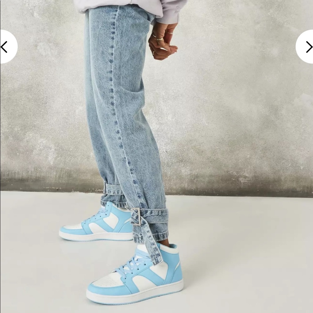 Light wash jeans with buckle detail on the bottom